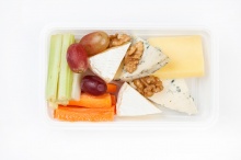 Cheese plate with vegetables, nuts and grape